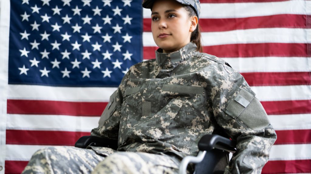 Army Soldier in a Wheelchair in Front of an American Flag