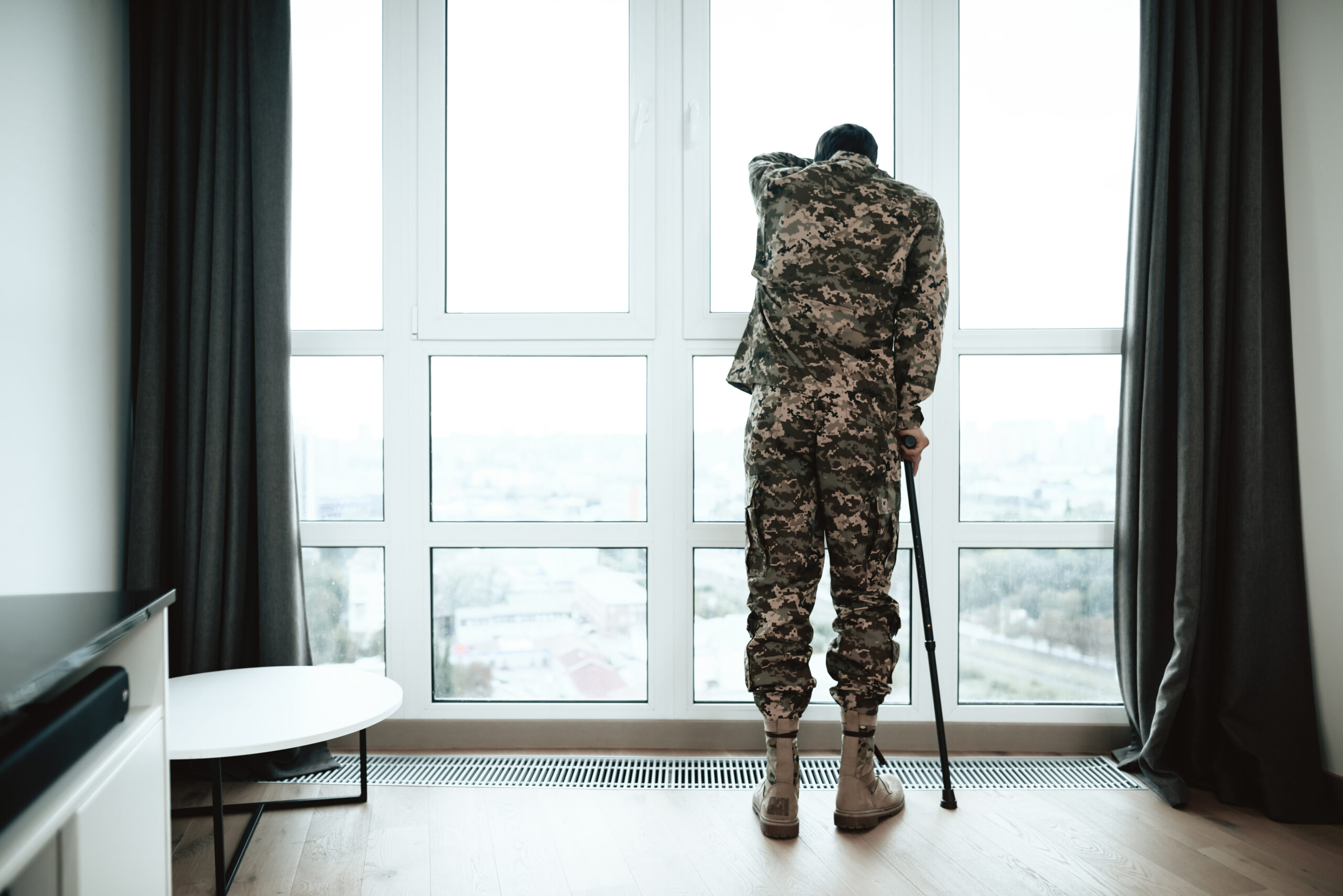disabled veteran standing with cane