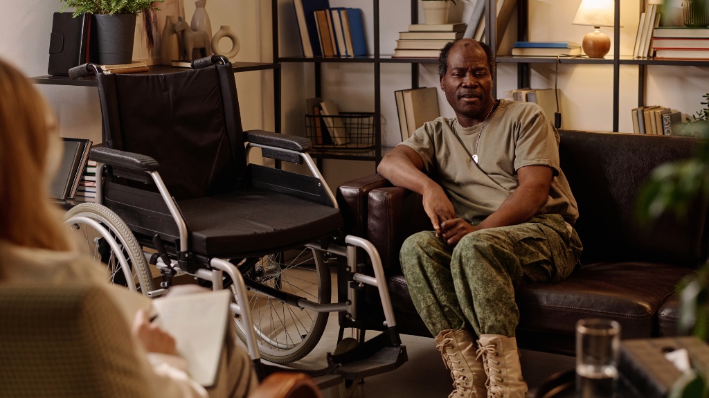 veteran with disability sitting on couch in relaxed pose