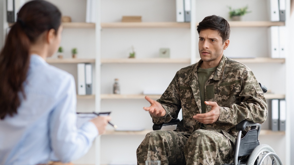 veteran in wheelchair speaks with lawyer
