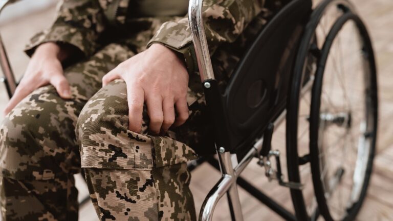 Someone in a wheelchair, wearing military gear