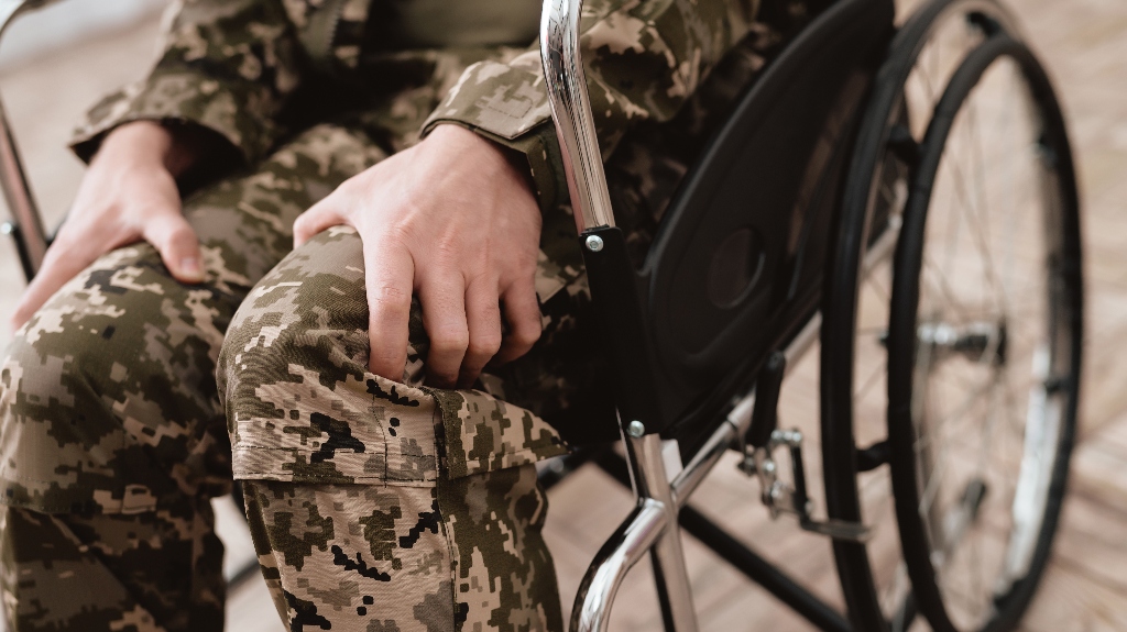 Someone in a wheelchair, wearing military gear